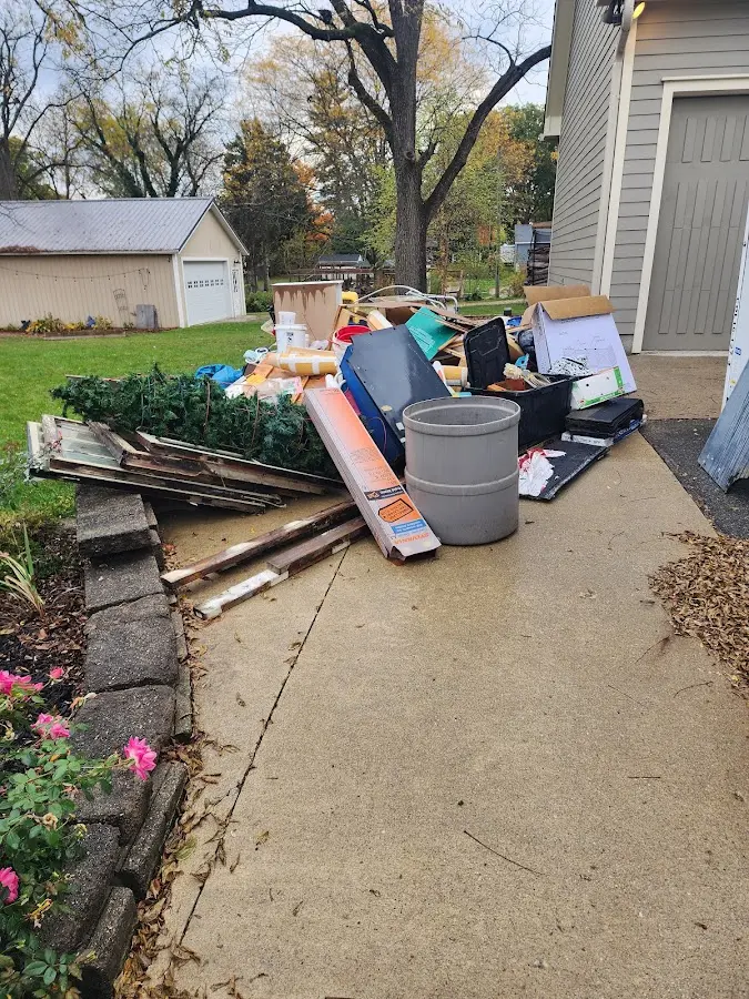 Dumpster being loaded with debris for Estate Cleanout Dumpster Rental in Chattahoochee